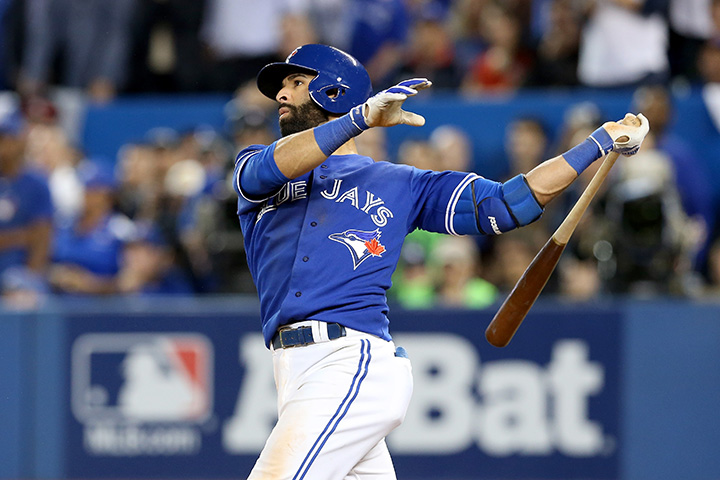 Jose Bautista of the Toronto Blue Jays hits a three-run home run in the seventh inning against the Texas Rangers in Game five of the American League Division Series at Rogers Centre on October 14, 2015 in Toronto.  