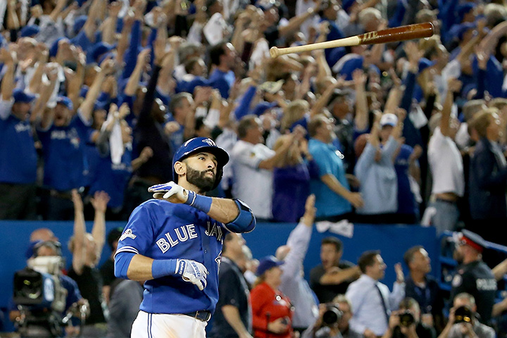 Jose Bautista of the Toronto Blue Jays throws his bat up in the air after he hits a three-run home run in the seventh inning against the Texas Rangers in Game 5 of the American League Division Series at Rogers Centre on October 14, 2015 in Toronto.  
