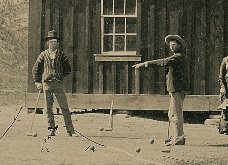 Billy the Kid, pictured on the left, leaning on a croquet mallet.