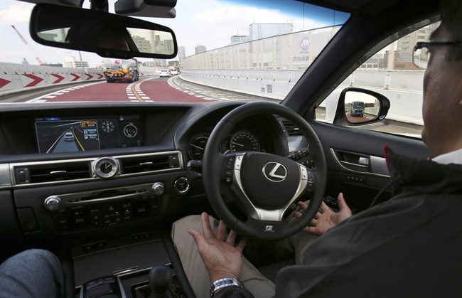 An employee of Toyota Motor Corp., drives automated driving test vehicle during a test drive of Toyota's self-driving technologies in Tokyo, Tuesday, Oct. 6, 2015. Toyota unveiled its vision for self-driving cars in a challenge to other automakers as well as industry newcomer Google Inc., promising to start selling such vehicles in Japan by 2020. Toyota Motor Corp. demonstrated on a regular Tokyo freeway Tuesday what it called the "mobility teammate concept," meaning the driver and the artificial intelligence in a sensor-packed car work together as a team.