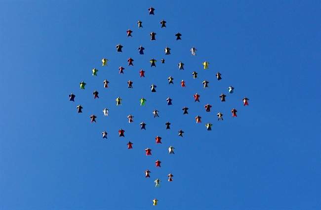 This photo taken, Oct. 17, 2015, and provided by Skydive Perris shows 61 wingsuit skydivers setting a new world record for the largest aerial formation in the sky over Perris, Calif., about 70 miles southeast of Los Angeles.
