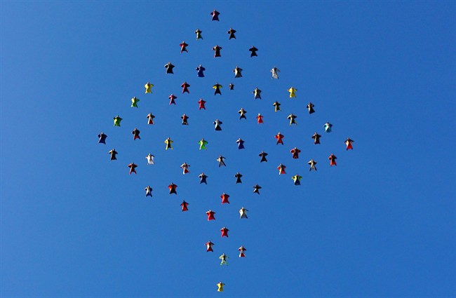 This photo taken, Oct. 17, 2015, and provided by Skydive Perris shows 61 wingsuit skydivers setting a new world record for the largest aerial formation in the sky over Perris, Calif., about 70 miles southeast of Los Angeles.