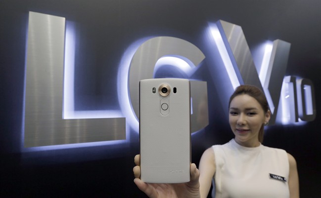 A model poses with LG Electronics Inc.'s new smartphone the V10 during its unveiling ceremony in Seoul, South Korea, Thursday, Oct. 1, 2015. LG Electronics Inc. unveiled a new smartphone Thursday with an additional screen and a camera that can capture a wider scene when taking a selfie, hoping to arrest a slide in its market share.