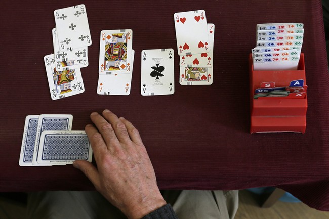 This is a Tuesday Sept. 22, 2015 file photo of a competitor playing bridge at the Acol Bridge Club in West Hampstead, London. 