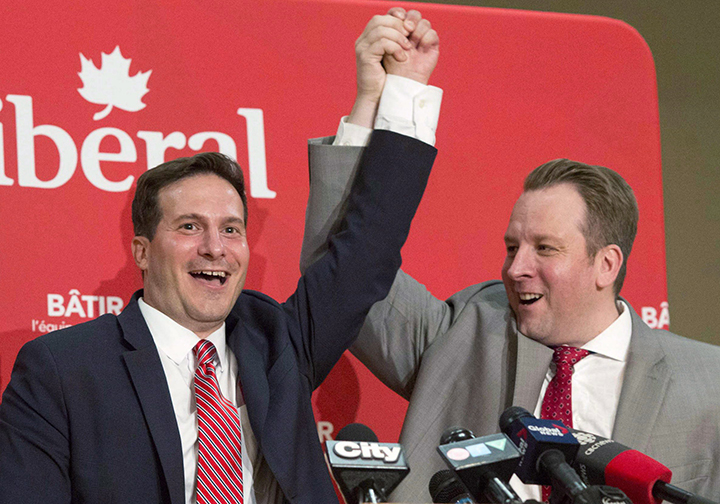 Marco Mendocino, left, has his hand held high by Party Chair Tyler Banham after Mendocino won the Liberal nomination for the Toronto riding of Eglinton-Lawrence on Sunday, July 26, 2015.