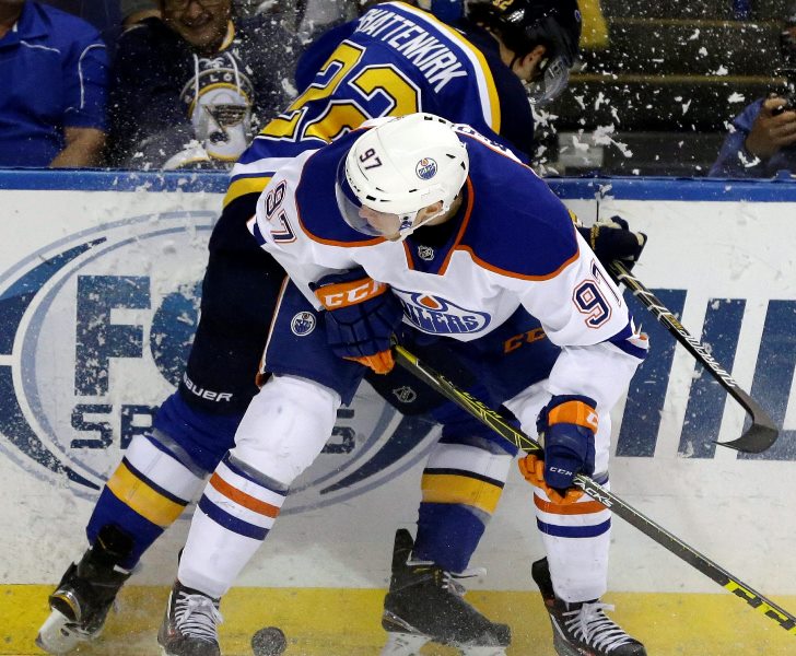 Edmonton Oilers' Connor McDavid, front, collides with St. Louis Blues' Kevin Shattenkirk along the boards during the first period of an NHL hockey game Thursday, Oct. 8, 2015, in St. Louis. (AP Photo/Jeff Roberson).