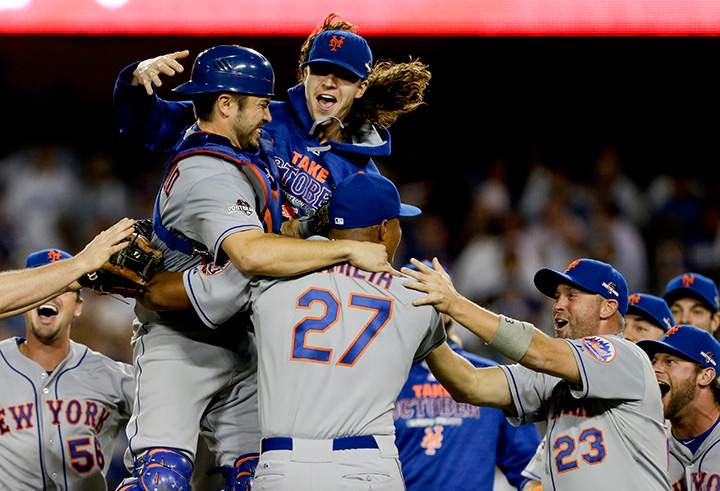 New York Mets starting pitcher Jacob deGrom, above right, catcher Travis d’Arnaud, left, and other Mets players celebrate a 3-2 win over the Los Angeles Dodgers in Game 5 of baseball’s National League Division Series on Thursday, Oct. 15, 2015, in Los Angeles.