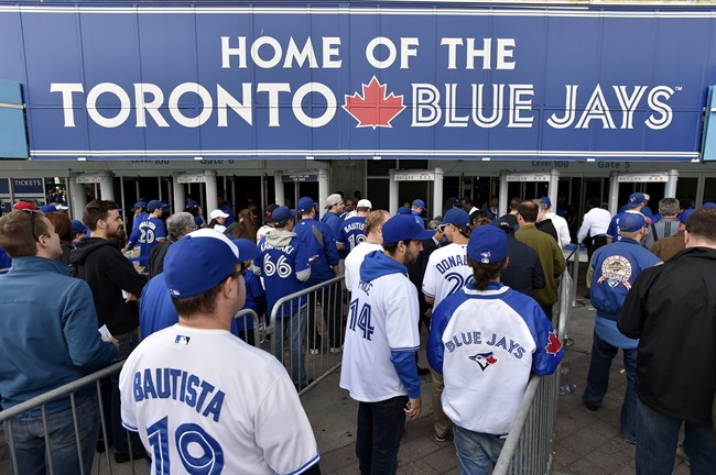Fans arrive for game one of the Toronto Blue Jays and Texas Rangers American League Division Series in Toronto on Thursday, Oct.8, 2015. THE CANADIAN PRESS/Nathan Denette.
