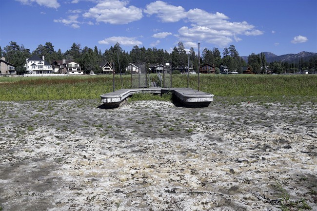 FILE – This Aug. 24, 2015, file photo, shows a boat dock by the lake bed where water has dried due to the drought at Big Bear Lake, Calif.