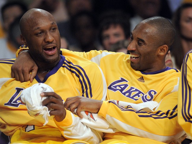 In this Nov. 18, 2008, file photo, Los Angeles Lakers guard Kobe Bryant, right, talks with forward Lamar Odom. 