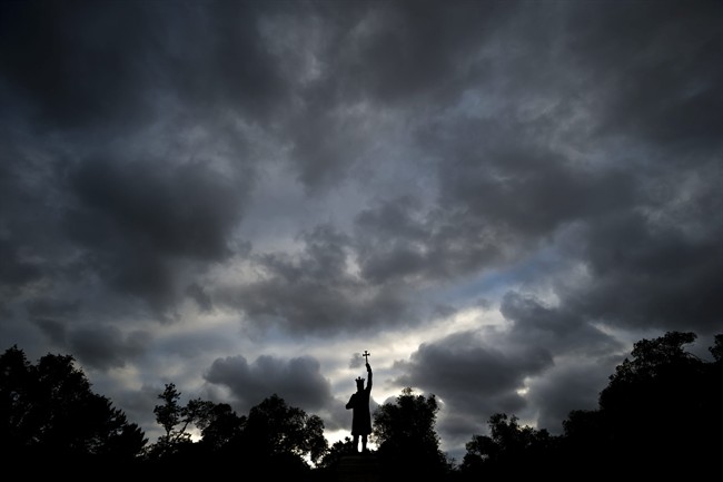 This Thursday, May 28, 2015 photo shows a statue of Stephen the Great (Stefan cel Mare in Romanian) silhouetted against a cloudy sky in Chisinau, the capital of Moldova.