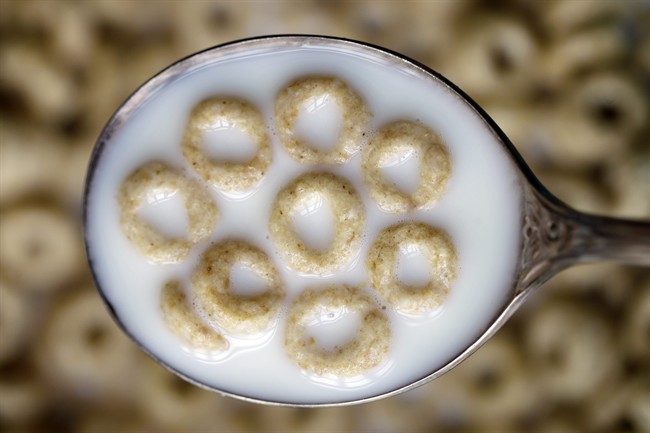 This file photo shows a spoonful of Honey Nut Cheerios in Pembroke, N.Y.