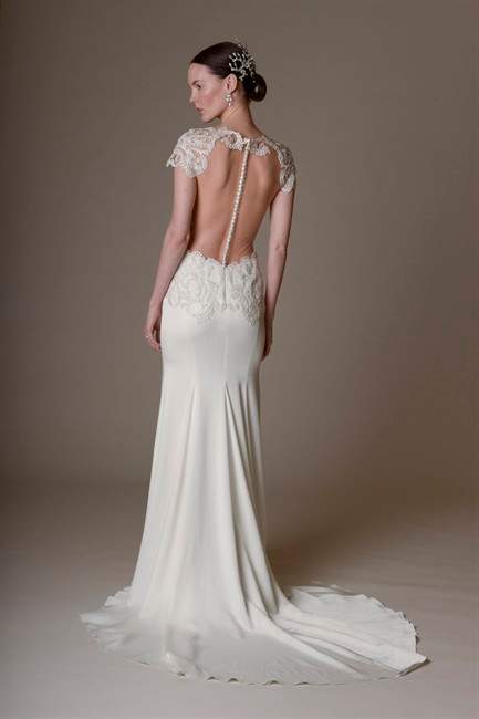 This photo provided by Marchesa shows a Spring Summer 2016 bridal gown. Some brides are stealing from the red carpets and going more risque for the big days with illusion styles, cut outs and ultra-sexy backs.