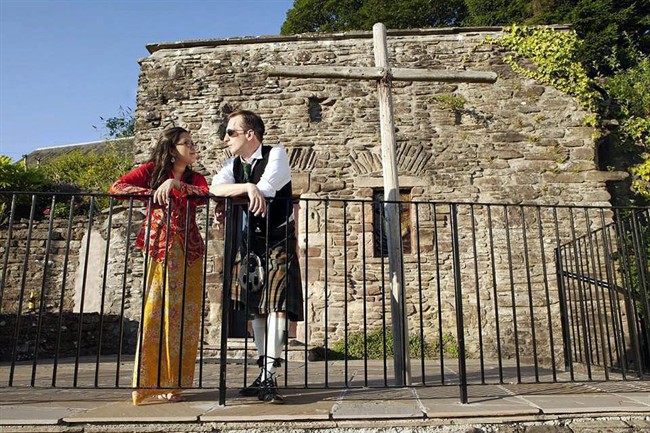 In this 2014 photo provided by Kirsten Han and Jenniflower Weddings shows Han, left, and Calum Stuart wearing traditional clothing from their native countries for their wedding reception in Dunblane, Scotland. Her gown is a Singaporean kebaya and his kilt is worn to honor his Scottish heritage. 