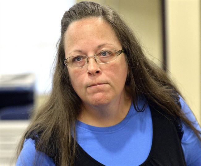 In this Tuesday, Sept. 1, 2015, file photo, Rowan County Clerk Kim Davis listens to a customer following her office's refusal to issue marriage licenses at the Rowan County Courthouse in Morehead, Ky.