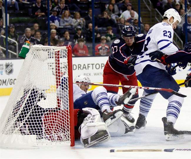 Columbus Blue Jackets goalie Sergei Bobrovosky (72), left, of Russia, makes a stop as Toronto Maple Leafs' Nazem Kadri falls on him behind Blue Jackets' Ryan Murray (27) and Maple Leafs' Shawn Matthias (23) during the first period of an NHL hockey game in Columbus, Ohio, Friday, Oct. 16, 2015.
