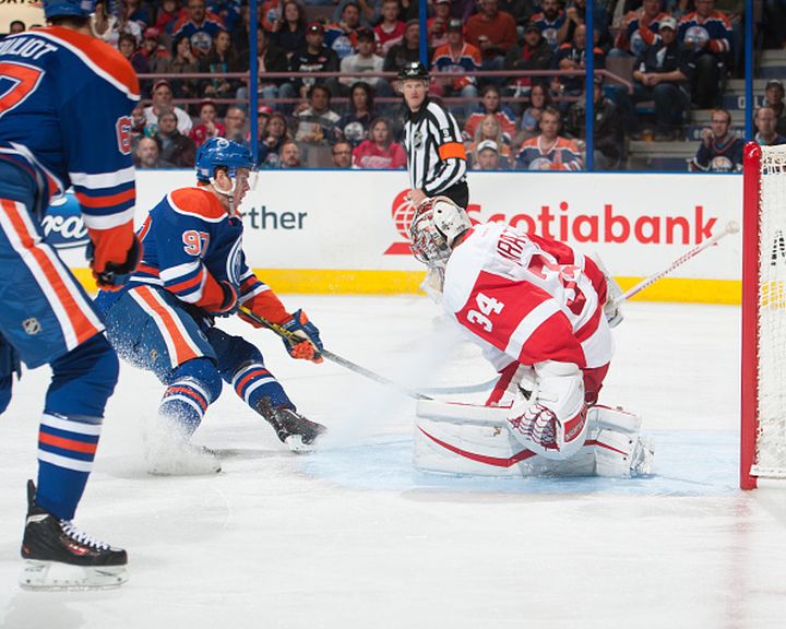 Connor McDavid #97 of the Edmonton Oilers takes a shot on Petr Mrazek #34 of the Detroit Red Wings during a game against the Detroit Red Wings on October 21, 2015 at Rexall Place in Edmonton, Alberta, Canada. 