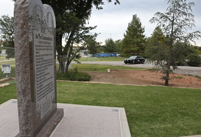 An Oklahoma State Highway Patrol car is parked near the Ten Commandments monument on the grounds of the state Capitol in Oklahoma City, Monday, Oct. 5, 2015.