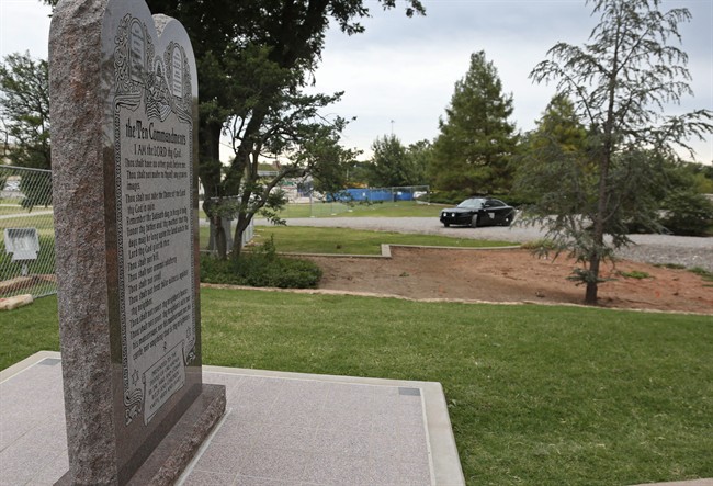 An Oklahoma State Highway Patrol car is parked near the Ten Commandments monument on the grounds of the state Capitol in Oklahoma City, Monday, Oct. 5, 2015. The Highway Patrol has increased security around the controversial monument as a court-ordered deadline looms for the sculpture to be removed. 
