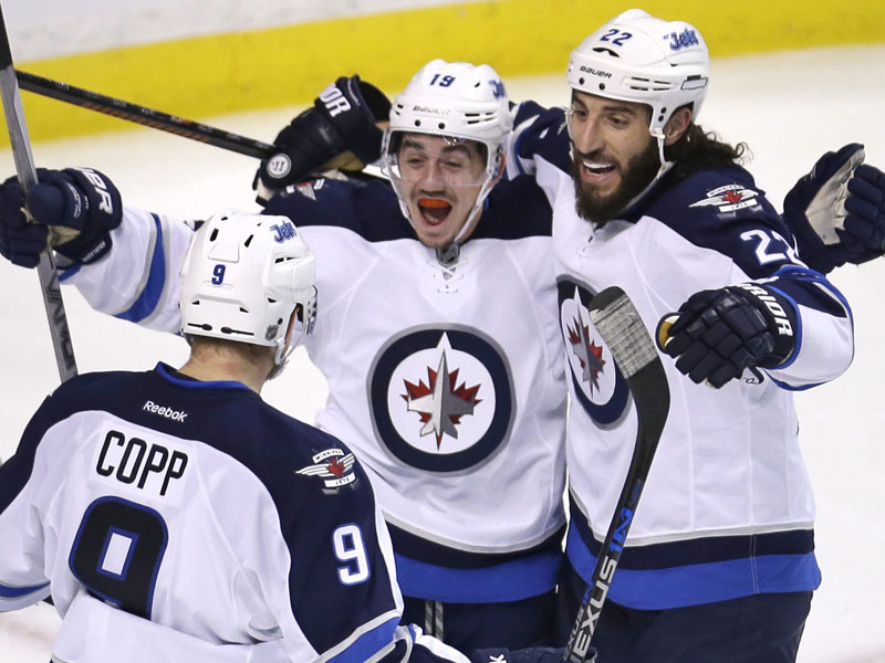 Winnipeg Jets center Nicolas Petan, center, celebrates with Chris Thorburn (22) and Andrew Copp (9) after his goal. 