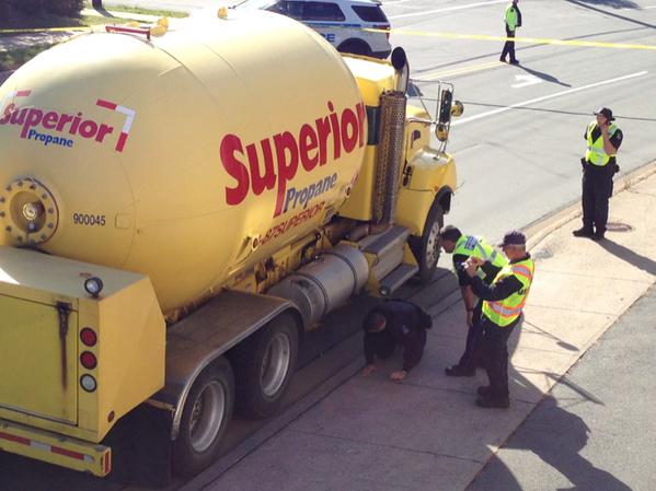 Police check propane truck that struck and killed a cyclist on Purcell’s Cove Road Wednesday.