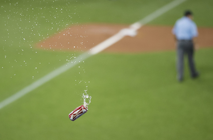 A beer is thrown onto the field toward the umpire crew during seventh inning game five American League Division Series baseball action between the Toronto Blue Jays and the Texas Rangers in Toronto on Wednesday, October 14, 2015.