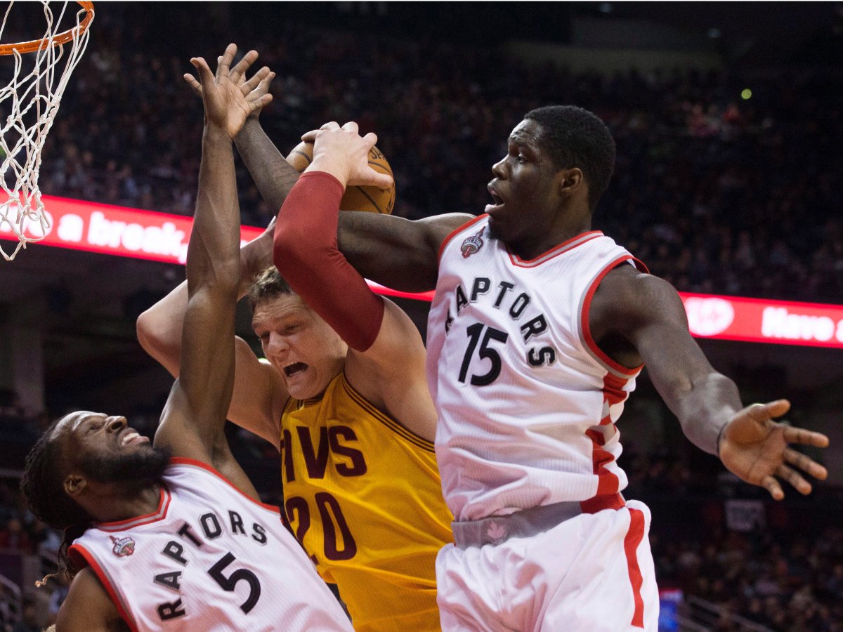Cleveland Cavaliers' Timofey Mozgov, centre, is fouled by Toronto Raptors' DeMarre Carroll, left, as Raptors Anthony Bennett defends during first half NBA pre-season basketball action in Toronto on Sunday, October 18, 2015. 