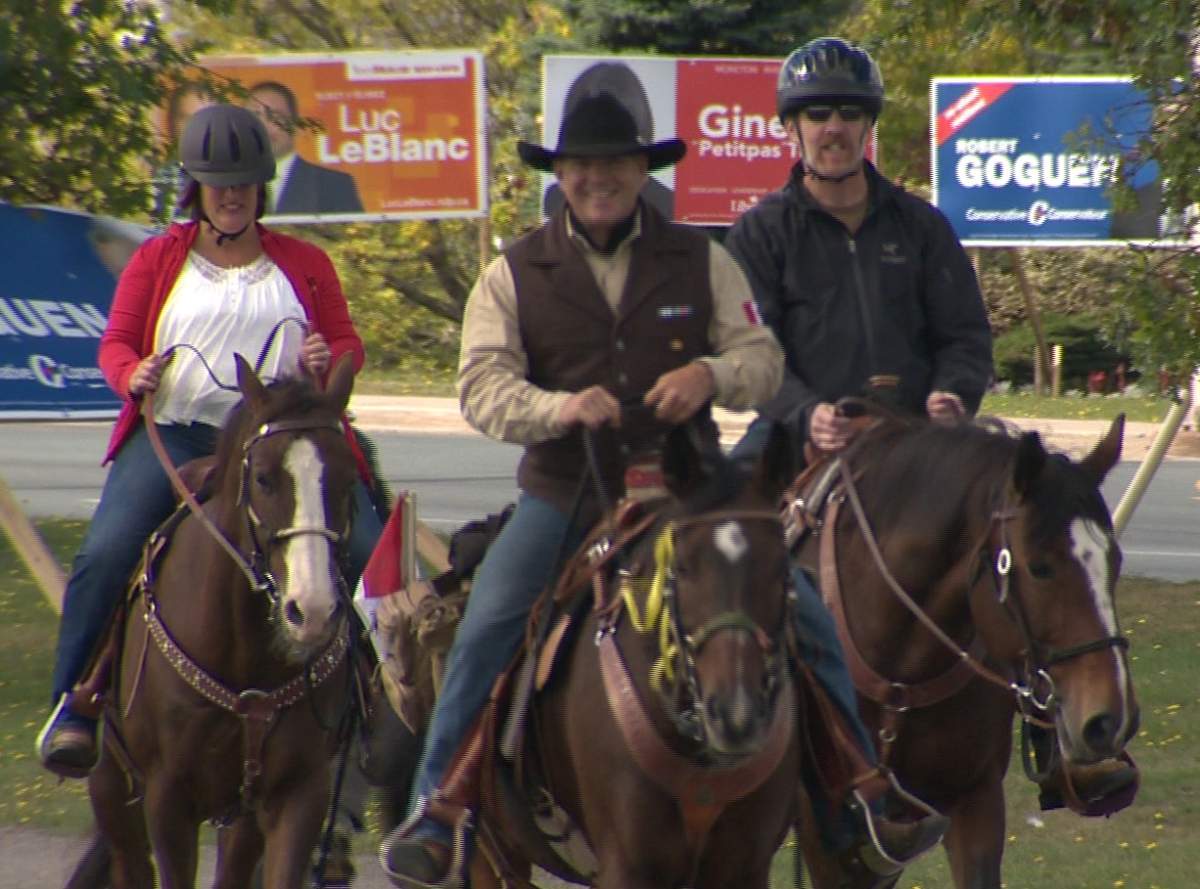 Veterans Paul Nichols, Danny Legace and Monique Barlett ride on a Moncton street.