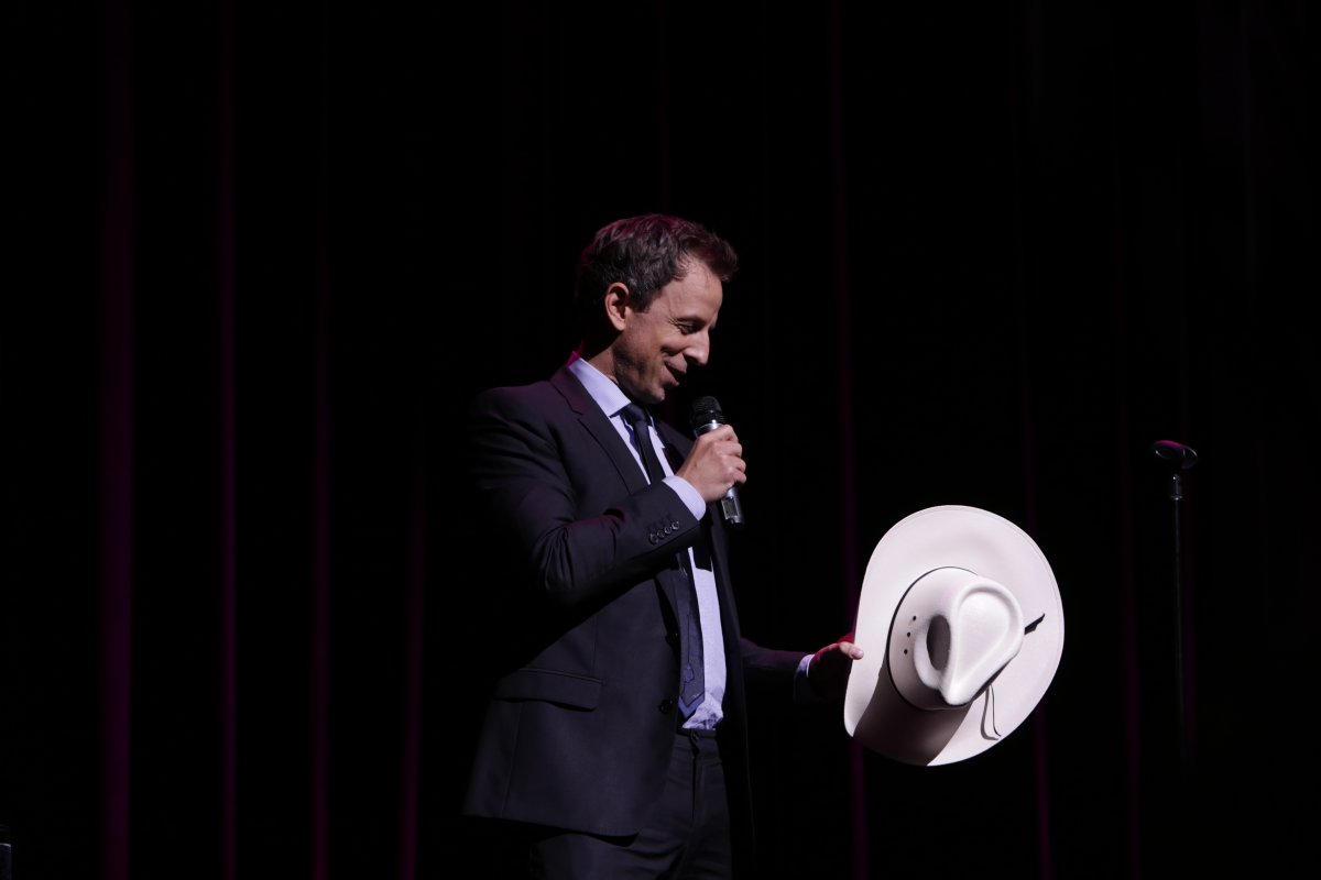 Seth Meyers with white cowboy hat, presented to him by Dr. Martha Hart, founder of Owen Hart Foundation.