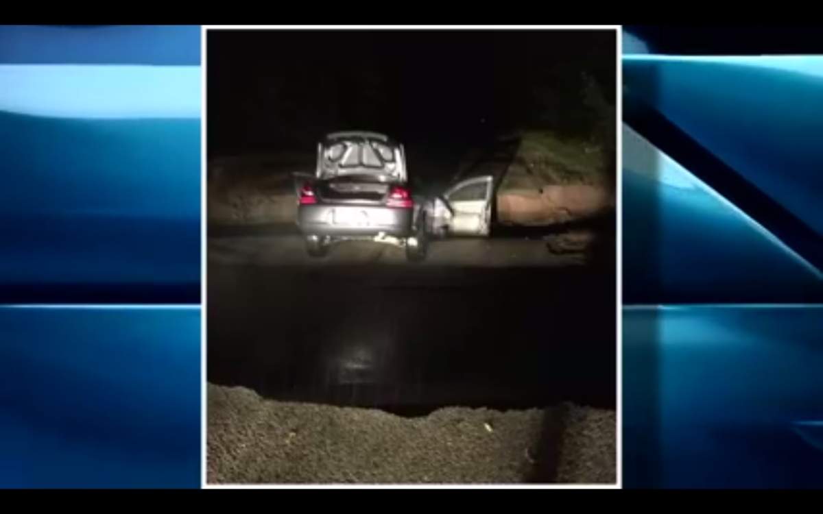 Couple escapes injury after driving car into sinkhole in rain storm - image