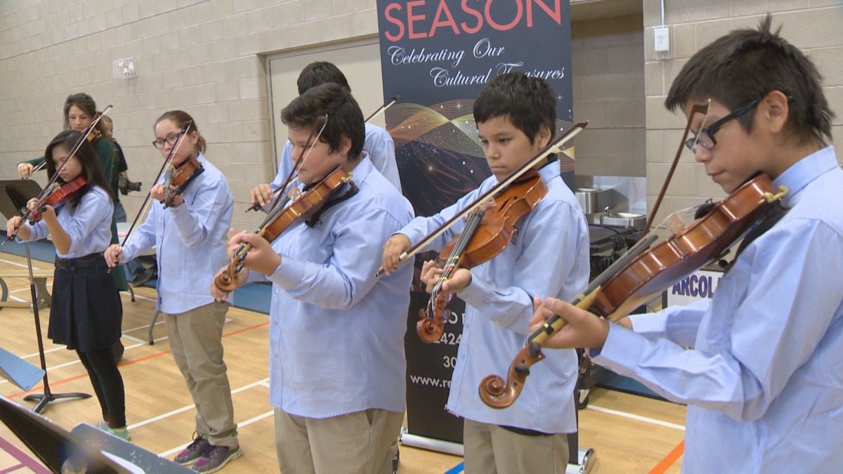 Grace 7 and 8 students from Mother Teresa Middle School demonstrate their violin skills they've learned through Strings for Change.