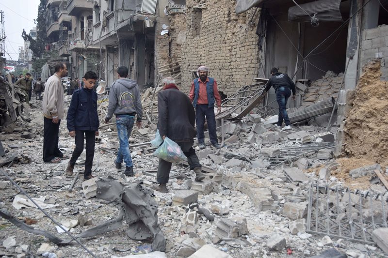 Residents inspect damage on the main field hospital in Douma after it was bombed by Syrian government air strikes in Douma, in north-east of Damascus suburb on October 29, 2015.