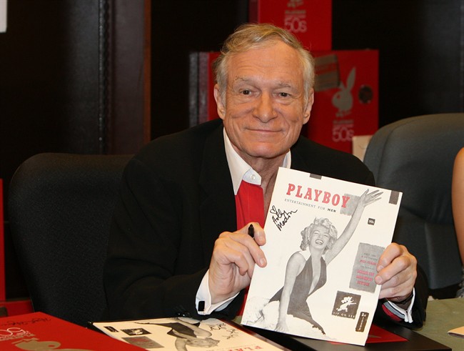 In this Nov. 15, 2007 photo, Hugh Hefner smiles while signing copies of the Playboy calendar and Playboy Cover To Cover: The 50's DVD box set in Los Angeles.