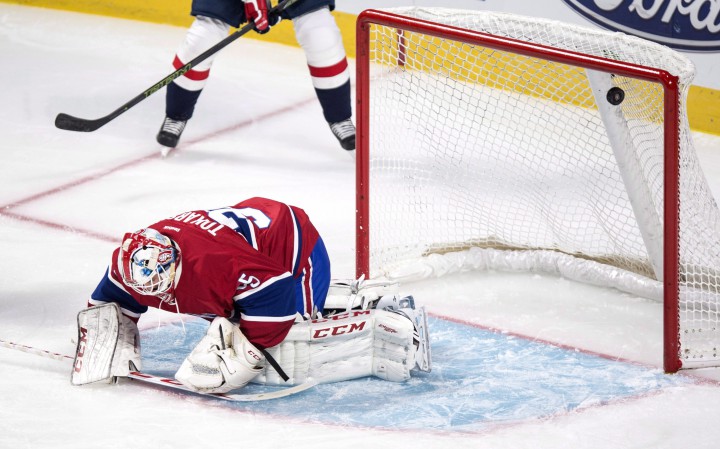 The puck flies high into the net past Montreal Canadiens goalie Dustin Tokarski on a goal by Washington Capitals' Andre Burakovsky during first period NHL hockey action Thursday, September 24, 2015 in Montreal.