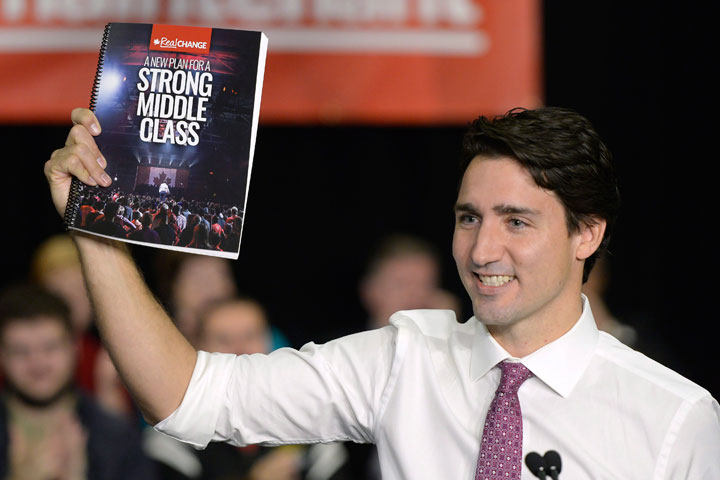 Liberal Leader Justin Trudeau holds up his party's platform at a press conference in Waterloo, Ont. on Monday, October 5, 2015.