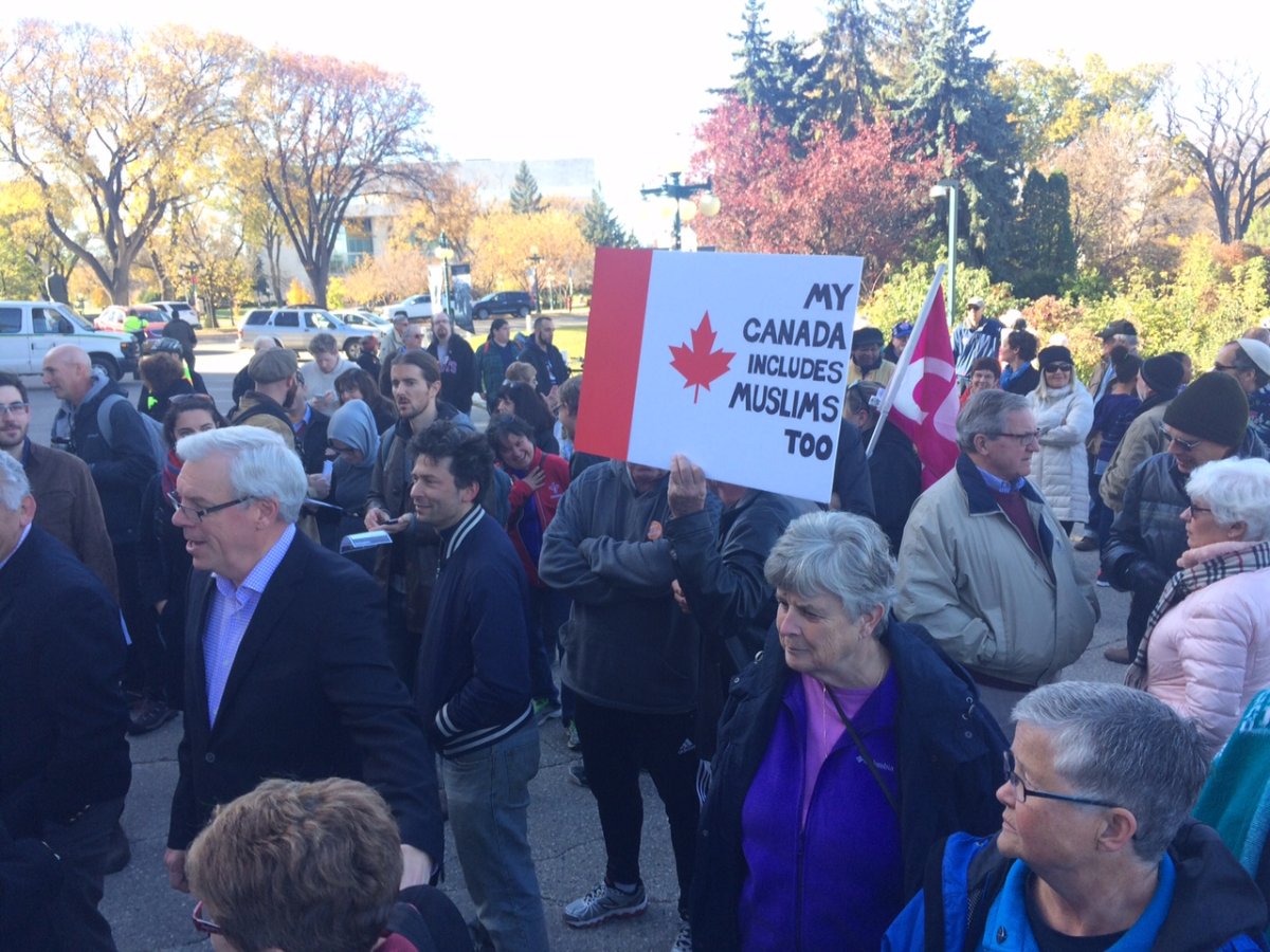 Dozens gather at the Manitoba Legislature for a unity rally Saturday.