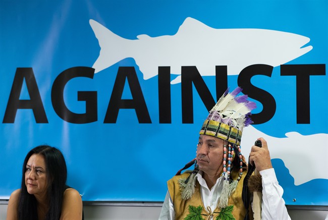 FILE PHOTO: Cheryl Bear, left, a councillor with the Nadleh Whut'en First Nation, and Hereditary Chief Pete Erickson, of the Nak'azdli First Nation, listen during a news conference about the Enbridge Northern Gateway pipeline in Vancouver, B.C., on Oct. 1, 2015.