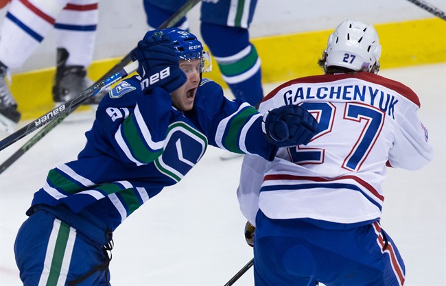 Vancouver Canucks' Jared McCann, left, celebrates his first goal beside Montreal Canadiens' Alex Galchenyuk during the first period of an NHL hockey game in Vancouver, B.C., on Tuesday, Oct. 27, 2015.