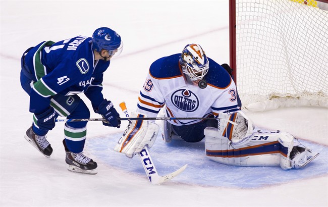 Edmonton Oilers goaltender Anders Nilsson (39) makes a save against Vancouver Canucks Sven Baertschi (47) during the second period of an NHL hockey game in Vancouver, B.C., on Sunday October 18, 2015. 