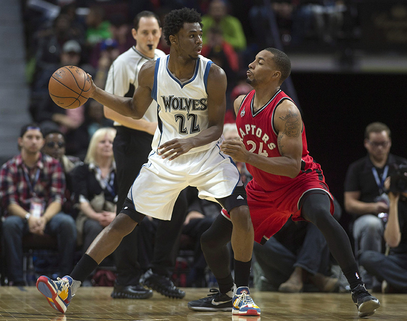Minnesota Timberwolves forward Andrew Wiggins drives to the net past Toronto Raptors guard Norman Powell. 