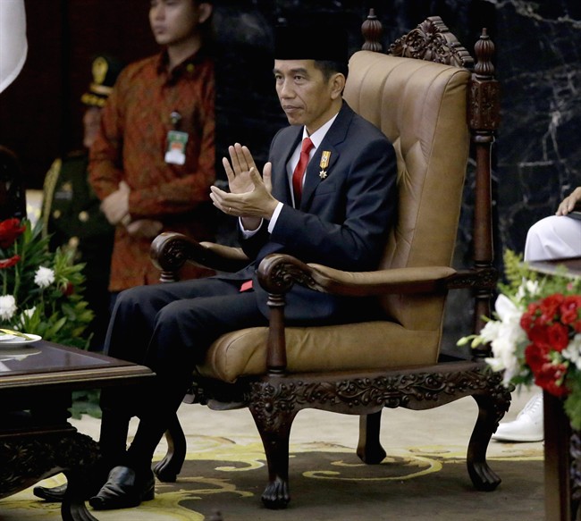 In this Aug. 14, 2015 file photo, Indonesian President Joko "Jokowi" Widodo applauds prior to speaking before Parliament members ahead of the country's Independence Day in Jakarta, Indonesia.