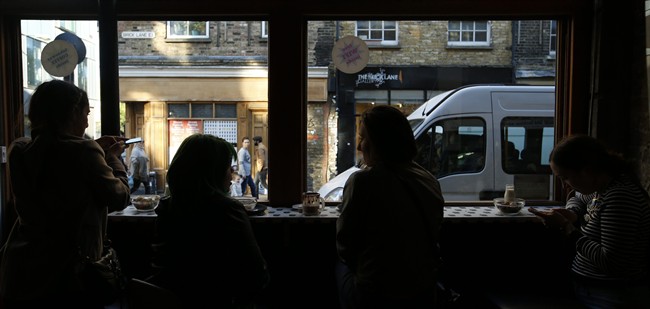 Customers take photos of their cereal selections as they sit next to the window of the Cereal Killer Cafe in Brick Lane London, Wednesday, Sept. 30, 2015.
