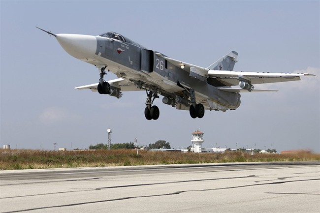 In this photo taken from Russian Defense Ministry official web site on Tuesday, Oct. 6, 2015, a Russian SU-24M jet fighter takes off from an airbase Hmeimim in Syria.