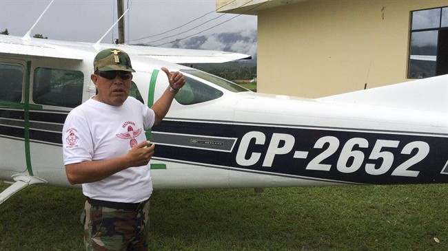 In this May 14, 2015 photo at the counternarcotics police base in Mazamari, Peru, police Cmdr. Jaime Pizarro shows The Associated Press a Cessna 206 plane seized in April after it got stuck in sand on a clandestine airstrip. According to police, the plane was on a mission to pick up cocaine in the Apurimac, Ene and Mantaro river valley, the world’s No. 1 cocaine-producing region. They said the pilot was arrested and the co-pilot fled with a satchel of cash.