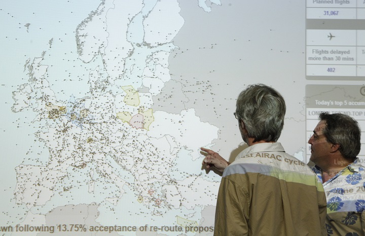 A man points at the Ukrainian airspace on an interactive map of flights over Europe, at the Eurocontrol headquarters, the European Organization for the safety of air navigation, in Brussels, Friday, July 18, 2014. (AP Photo/Yves Logghe).