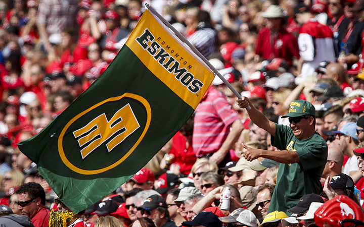 An Edmonton Eskimos' fan cheers during first half CFL football action against the Calgary Stampeders in Calgary, Alta., Monday, Sept. 1, 2014.