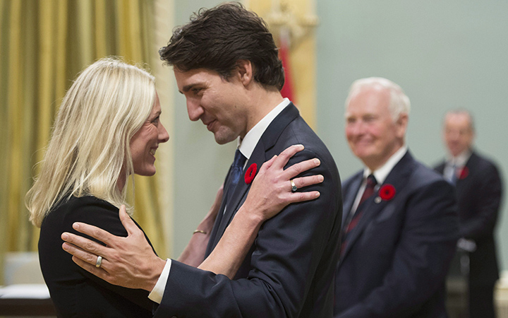 Prime Minister Justin Trudeau hugs Environment and Climate Change Minister Catherine McKenna at Rideau Hall in Ottawa on Wednesday, November 4, 2015.