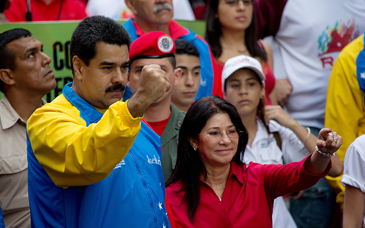 Venezuela's President Nicolas Maduro and first lady Cilia Flores, greet supporters as they arrive for a march for peace in Caracas, Venezuela. Two nephews of Venezuela's powerful first lady Cilia Flores have been arrested in Haiti on charges of conspiring to smuggle 800 kilograms of cocaine into the U.S.