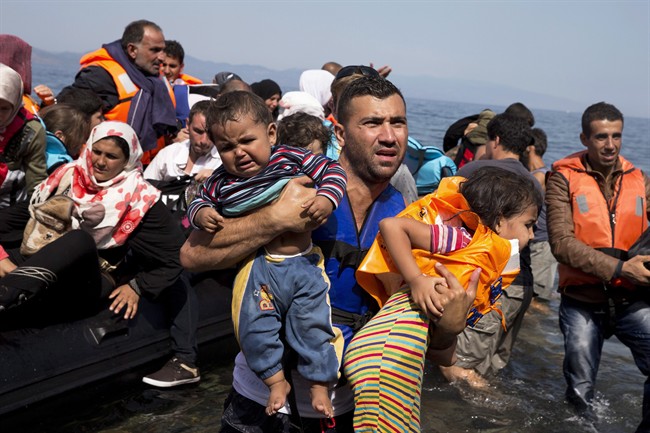 Syrian refugees arrive aboard a dinghy after crossing from Turkey to the island of Lesbos, Greece, in this Sept. 10, 2015 file photo. 