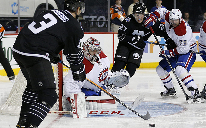 Montreal Canadiens goalie Carey Price  stops a shot by New York Islanders defenseman Travis Hamonic during the second period of an NHL hockey game Friday, Nov. 20, 2015, in New York. 